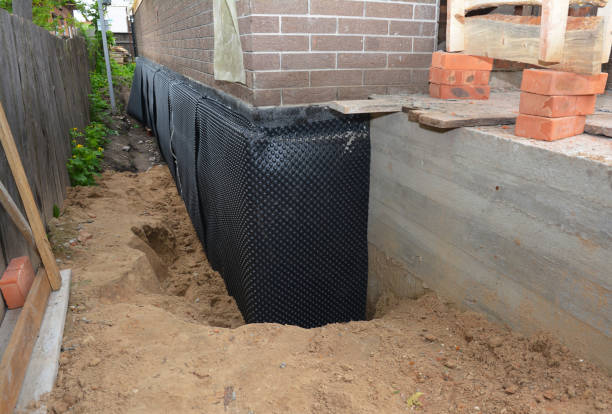 Happy homeowners after waterproofing job in Brohman